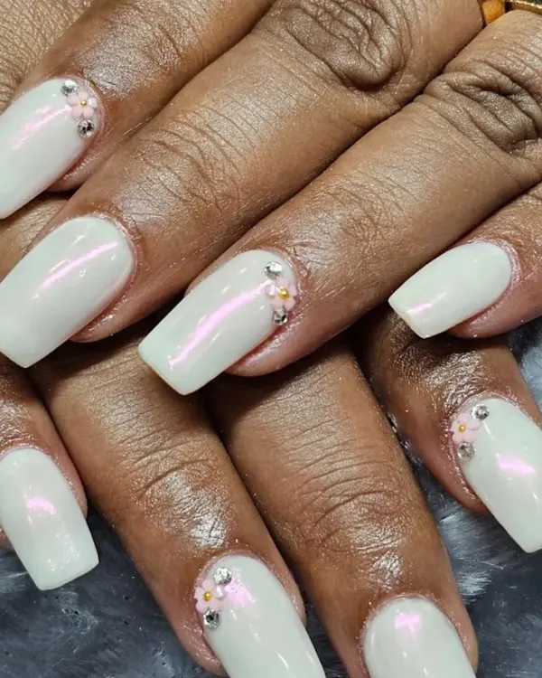 A beautiful set of square nail extensions with a pearly white chrome finish. I added delicate pink and silver rhinestones at the cuticle for a touch of sparkle, creating an elegant look perfect for any occasion.