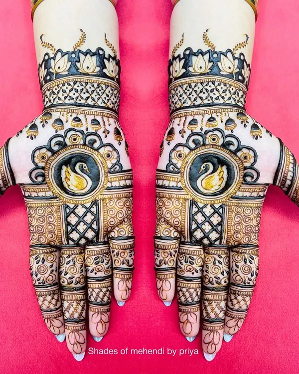 A beautiful and symmetrical design for a Roka ceremony. It features swan motifs enclosed in circles, with intricate checkerboard patterns and delicate details on the fingers.