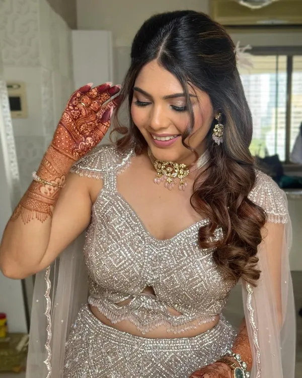 For this glamorous engagement look, I styled the hair in a voluminous half-up style with cascading curls. This hairstyle pairs beautifully with heavily embellished outfits.