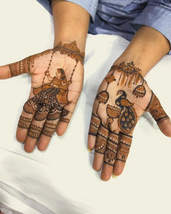 This design for the Sawan season features a woman on a swing on one palm and a peacock with jhumkas on the other. The distinct themes on each hand tell a beautiful story of monsoon celebrations.