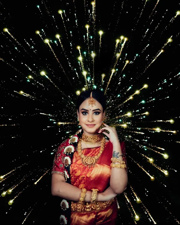 A stunning bridal portrait using a creative firework lighting effect. The bride stands confidently as the light bursts around her, symbolizing a celebration of her new beginning.