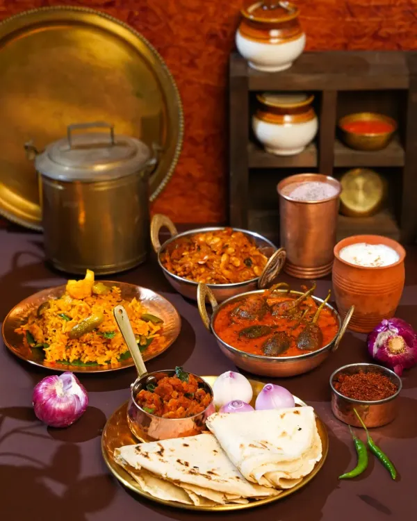 A tribute to the heart of Maharashtra. This spread, inspired by my travels in Ratnagiri, features authentic dishes like Bharli Vangi and Bhakri, styled with traditional brass and copper utensils to recreate the soul of a village kitchen.
