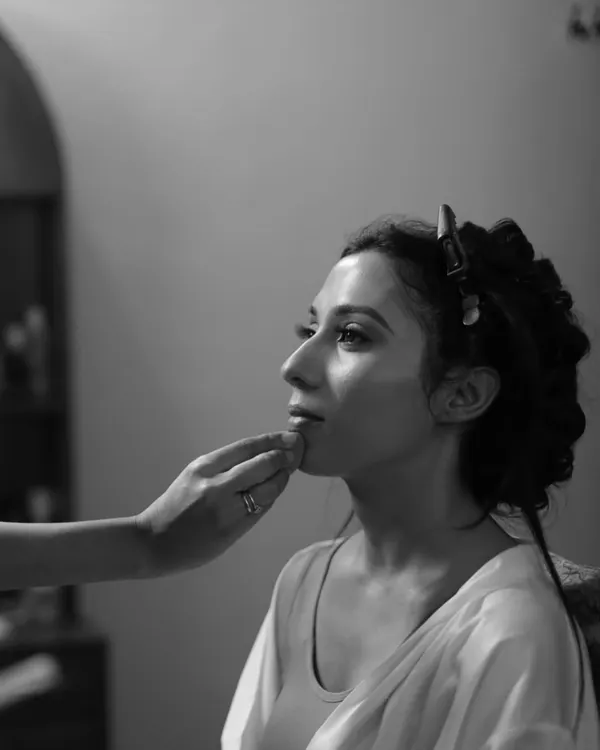 A quiet moment of focus. This black and white shot captures the artistry and precision that goes into every makeup application. We teach our students to approach their work with the focus of a true artist.