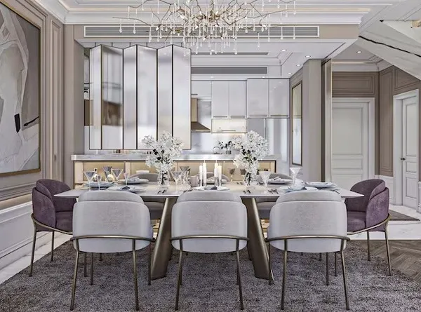 A luxurious open-plan dining area featuring a marble-top table, plush velvet chairs, and a mirrored partition that adds depth and glamour to the space.