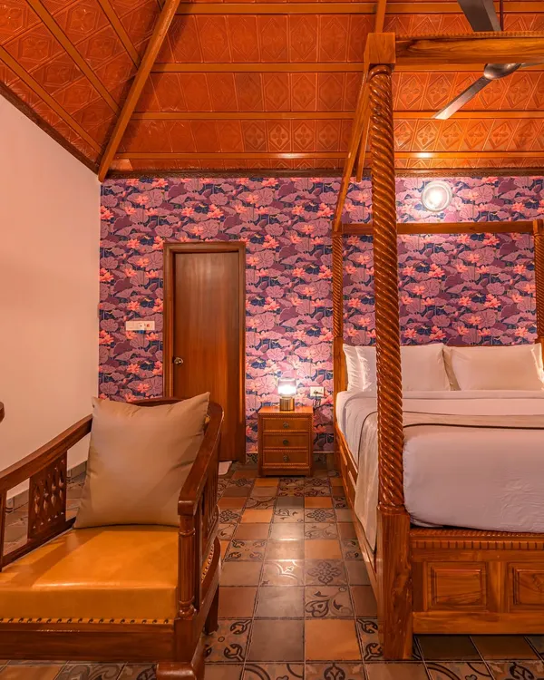 This is a bedroom I designed for Brown Town Resorts in Hyderabad, embracing a timeless earthy aesthetic. The four-poster bed, patterned floor tiles, and bold wallpaper create a space that feels both traditional and luxurious.