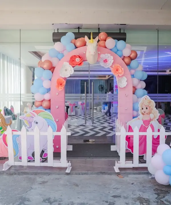 A fairy tale entrance for a little princess. This unicorn and princess-themed gate features a pink balloon arch, character cutouts, and a personalized welcome sign to greet guests with a touch of magic.