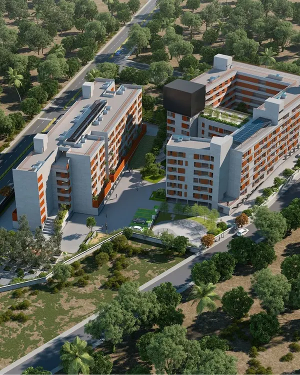 An aerial view of the Mysuru community living project, showing how the two building blocks are arranged to create a protected, vibrant central courtyard. This layout is key to fostering a sense of a shared neighborhood within the development.