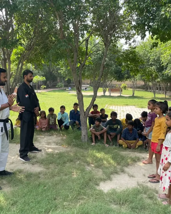 We believe in starting young. Here, we are teaching the basics of martial arts to a group of children in an outdoor society class, focusing on discipline, coordination, and fun.