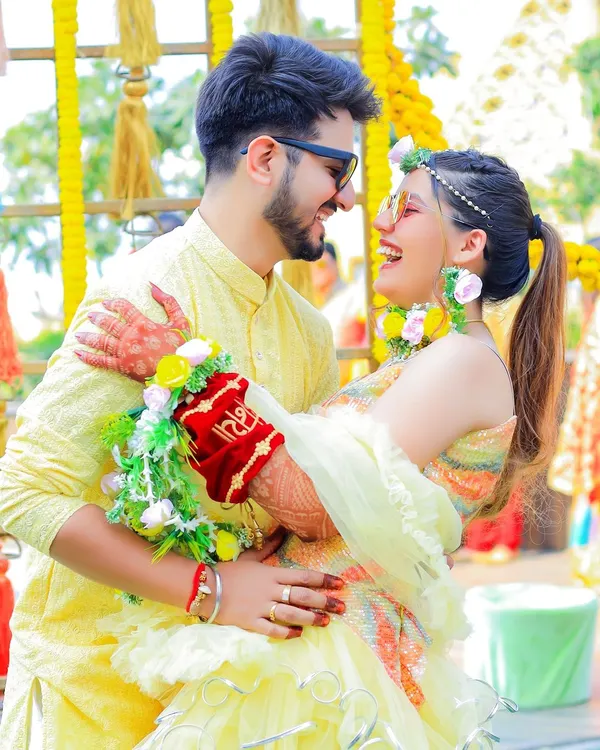 The pure, unscripted joy of a Haldi ceremony. This candid shot of the couple sharing a laugh is what we love to capture, preserving the genuine happiness and playful spirit of the day.