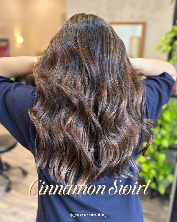 This Cinnamon Swirl is the perfect way to add warmth and dimension to dark hair. The subtle, swirling highlights catch the light beautifully with every movement.