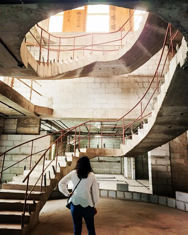 A powerful shot of a custom concrete spiral staircase under construction. This is where architectural vision takes physical form, showcasing our ability to execute complex and ambitious designs.