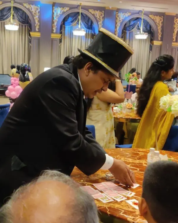 Performing close-up card magic at a private event. This intimate style of performance allows guests to experience the astonishment firsthand, right at their table.