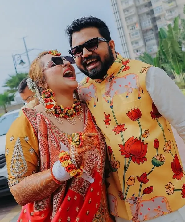 For me, the best shots are the unscripted ones. This candid photo from a Haldi ceremony captures a moment of pure, uninhibited laughter between the couple, showing the real fun and 'hasi-masti' of a wedding.