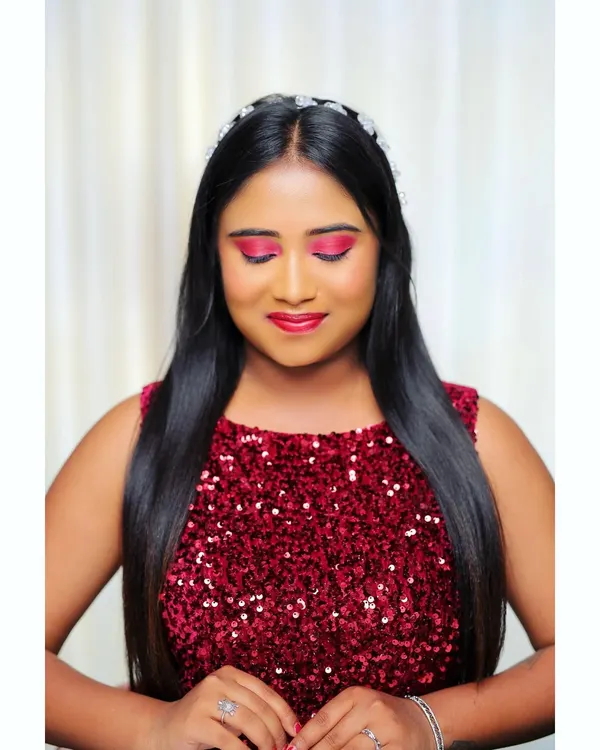 This is a perfect example of a cocktail party look. The focus is on the vibrant pink eyeshadow and glowing skin, paired with a sequined red dress for a fun and glamorous feel. The hair is styled sleek and straight with a simple headband.