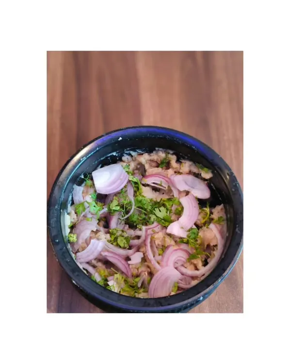 This is Eromba, a traditional Manipuri dish. It's made by mashing boiled vegetables with fermented fish and a lot of chilli, topped with fresh onions.