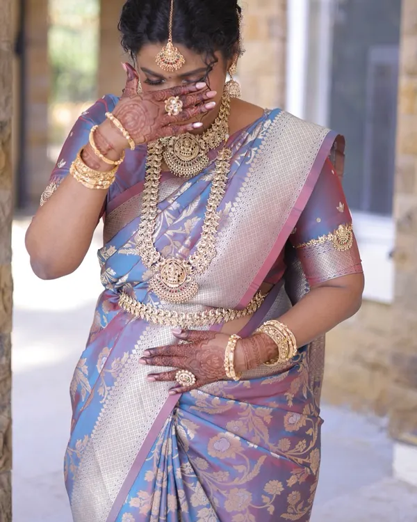 A candid, emotional moment from a wedding day. Our full temple jewellery set, including the intricate kambarpatta and bajuband, added to her stunning bridal glow.