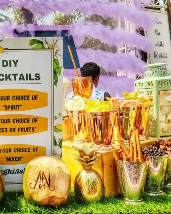 The complete setup for my DIY Cocktails station. A clear sign guides guests to pick their spirit, spice or fruit, and mixer, while engraved coconuts and stylish copperware add a premium touch to this interactive gin bar.