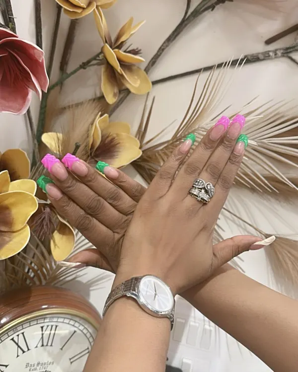 A bold and playful twist on the French manicure. This design features long, square-shaped nails with alternating neon pink and green tips for a vibrant, color-blocked look.