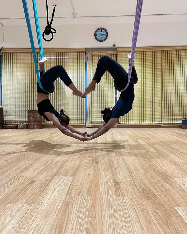 This is what partner aerial yoga is all about: trust, support, and creating something beautiful together. It's a fun challenge that builds connection and strength at the same time.