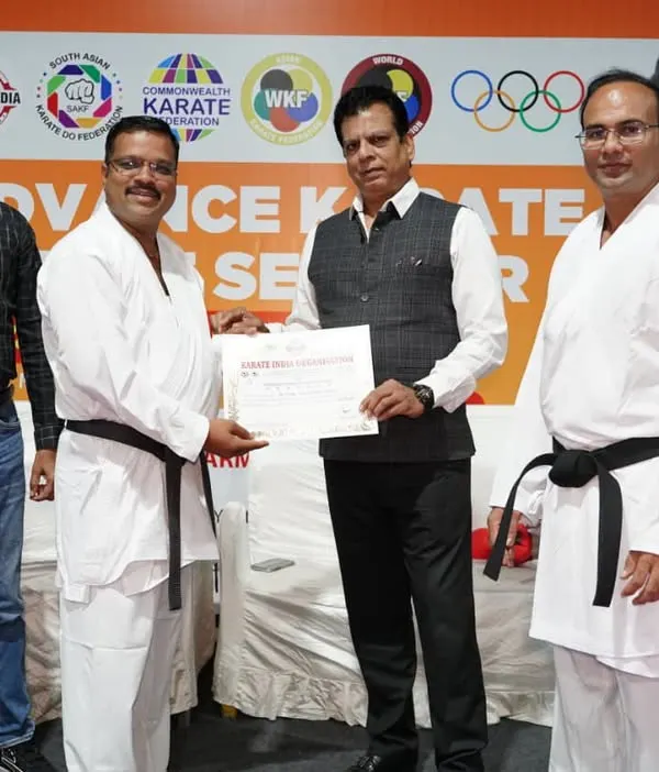 Presenting a certificate at the conclusion of an Advance Karate Kumite Seminar in Pune, Maharashtra. Continuous education for athletes and coaches is a top priority.