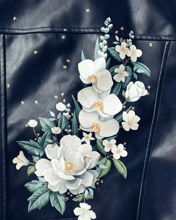 A beautifully hand-painted floral design on a leather jacket, showcasing an exciting way to upcycle your wardrobe.