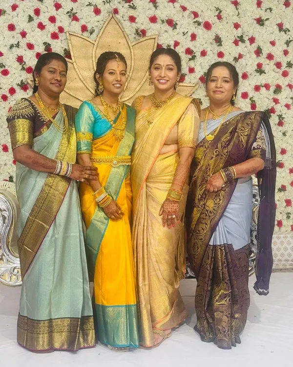 A beautiful family portrait from a wedding celebration. Our client Geeta (in gold) and her sisters and cousins are all draped in the regal artistry of Mathura Creations sarees.