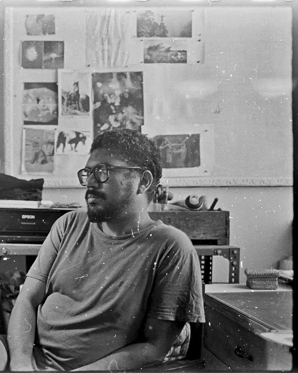 A candid portrait taken on black and white film, showing our darkroom manager Krishanu in the studio. There's a certain character and texture to film grain that digital can't replicate.