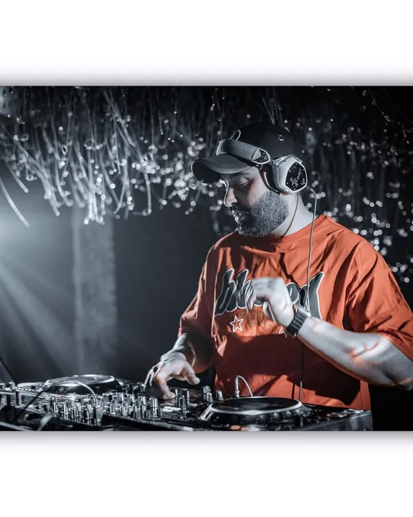 A black and white shot capturing me in the zone, mixing tracks under the spotlight. This is where I feel most at home, focused on the music and the crowd's energy.