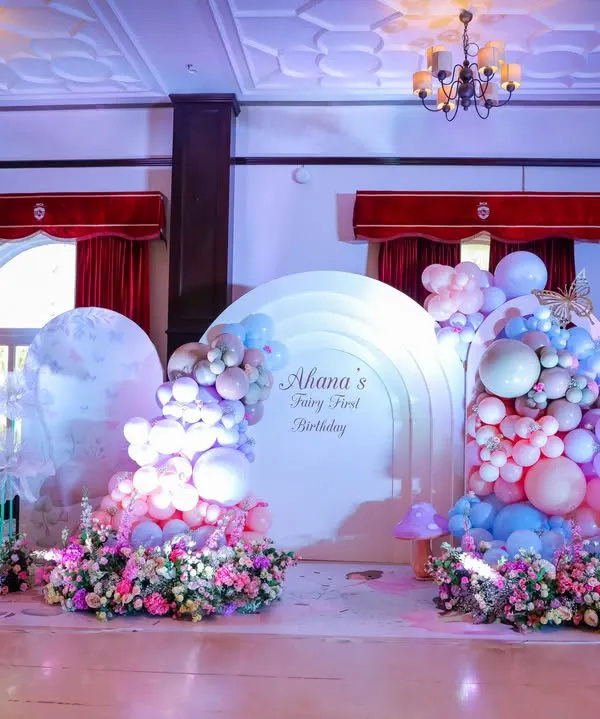 Welcome to a fairy wonderland. For this first birthday, we transformed the space with dreamy pastel balloon clouds, oversized paper flowers, and magical mushroom props, creating an enchanted forest for everyone to explore.