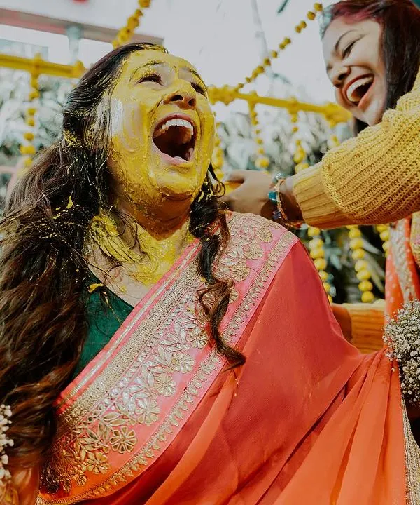 This is the pure, uninhibited joy of a haldi ceremony. We live for capturing these moments of explosive laughter and celebration as the bride is covered in turmeric by her loved ones.