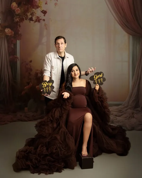 The big question: boy or girl? This fun couple's portrait captures the suspense and excitement before a gender reveal.
