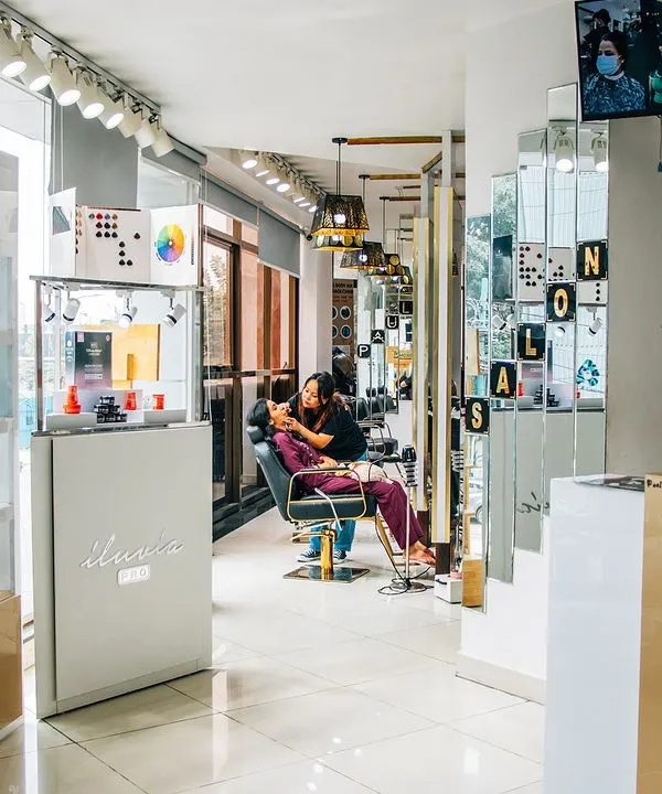 A view of our salon floor and product display. We stock professional brands like L'Oréal and Schwarzkopf to support all our hair and beauty treatments.