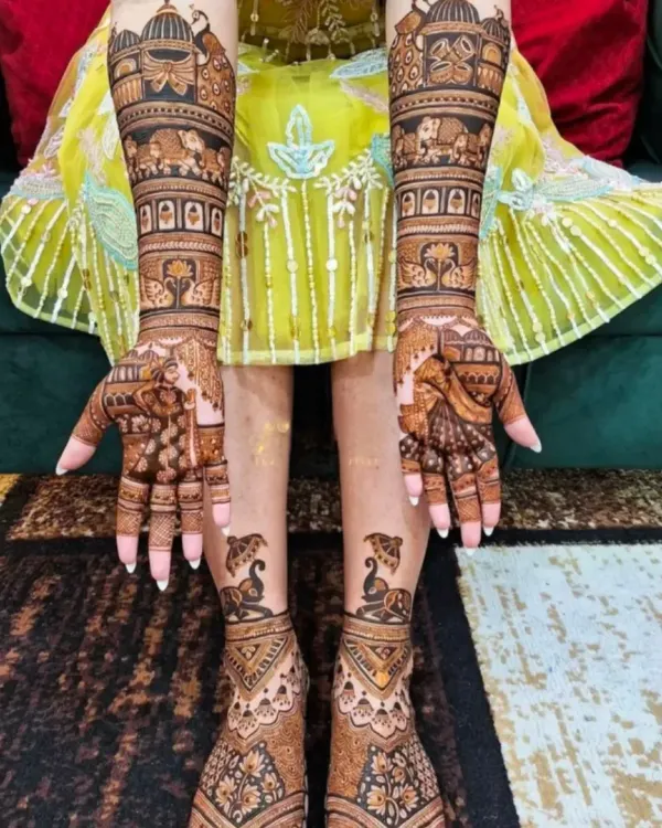 This complete bridal set features matching designs on the hands and feet, with elephant processions and palace architecture as the central theme.
