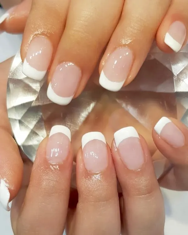 You can never go wrong with a classic French manicure. This clean and simple design uses white tips on a natural base for a polished and sophisticated look.
