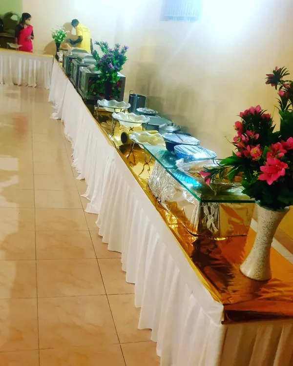 A straightforward and clean buffet line for a smaller corporate gathering. This setup is functional and efficient, perfect for office lunches or internal meetings.