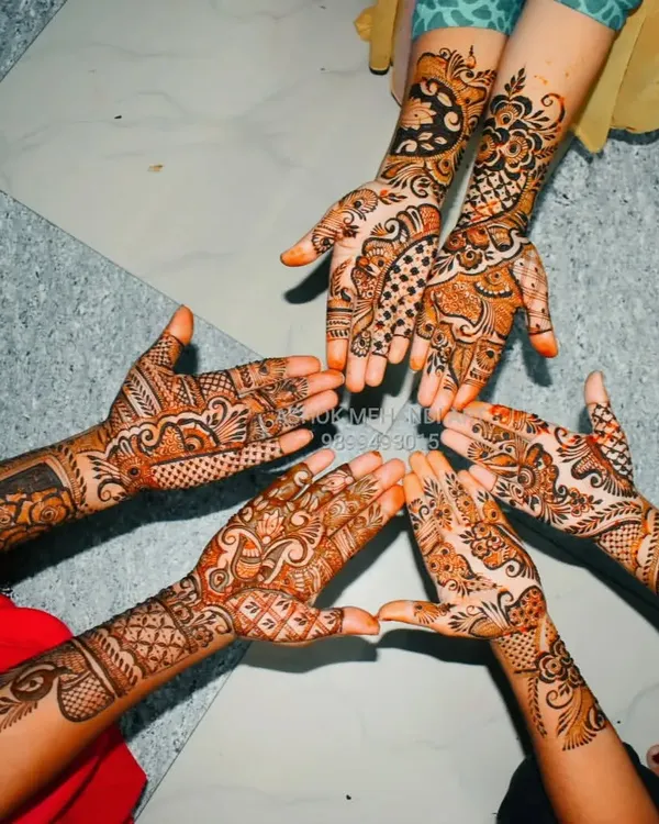 A beautiful shot of a group of friends showing off their coordinated mehndi designs. I love working with groups to create patterns that are similar in style but unique to each person.