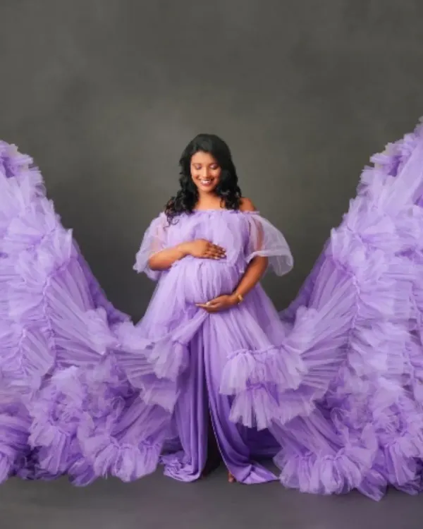 Feel like an angel in this breathtaking lavender tulle gown. The dramatic wing-like sleeves create a truly magical and unforgettable silhouette, perfect for a statement maternity portrait that celebrates your divine journey.