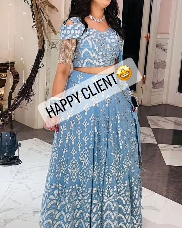 A happy client looking stunning in a powder blue lehenga with silver embroidery. Her smile says it all.