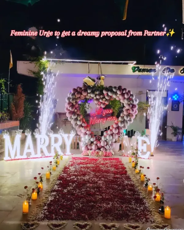 This is what the beginning of forever looks like. I helped create this magical proposal with a heart made of balloons, a path of soft rose petals, and glowing "MARRY ME" letters. The finishing touch of cold pyros made the moment truly unforgettable.