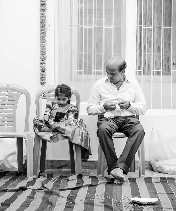 A quiet, beautifully framed black and white shot of a grandfather and granddaughter sitting together. We are always watching for these simple, slice-of-life moments that tell a deeper story.