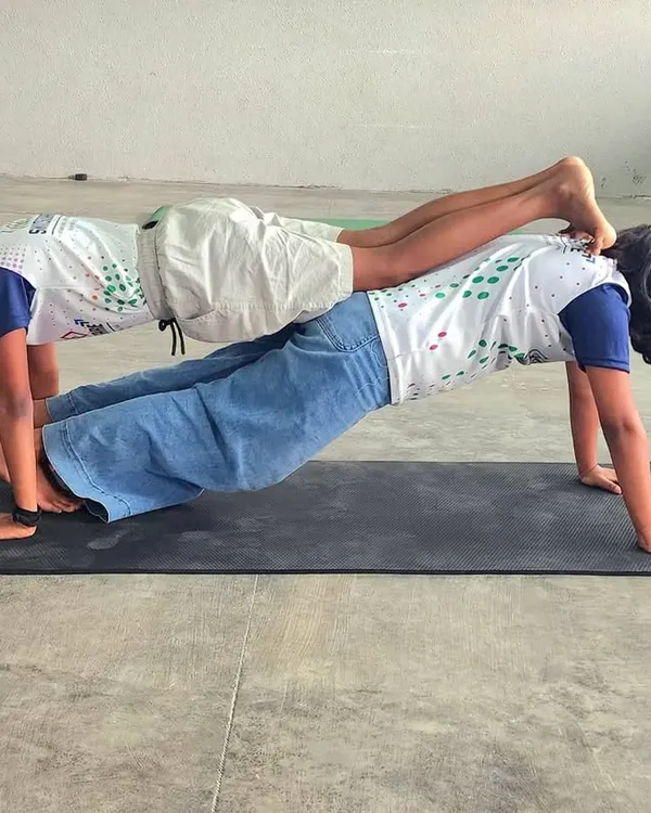 This partner plank is a fantastic exercise for building core strength and endurance. It requires both children to work together, synchronizing their stability and focus.