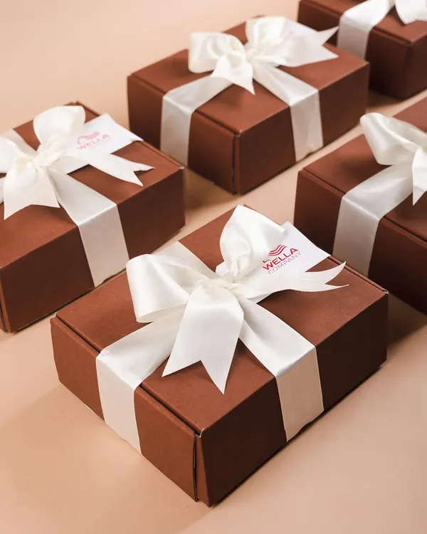 Minimalist and elegant corporate hampers for Wella. These simple brown boxes with a crisp white satin ribbon prove that sometimes, less is more.