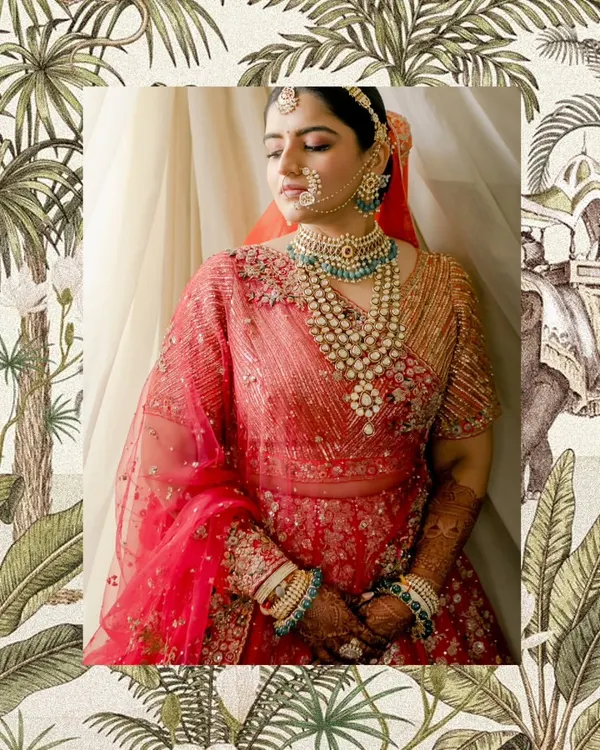 A portrait of bridal grace. We chose this stunning red lehenga for its intricate embroidery and paired it with layered Polki and emerald jewelry. The final look was a perfect blend of traditional elegance and modern bridal style.