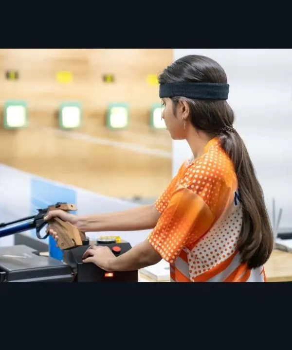 A young pistol shooter hones her technique during a practice session. Our training emphasizes correct form and mental focus from the very beginning.