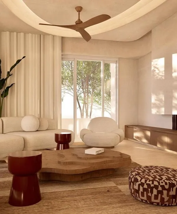 The main living area of Kumo House, designed as a tranquil gathering space. The design emphasizes natural materials and a soft, earthy color scheme to create an atmosphere of warm minimalism.