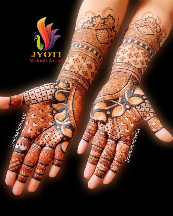A stunning example of full-coverage bridal mehndi. This design uses negative space and bold lines to create a striking pattern that extends up the arm.