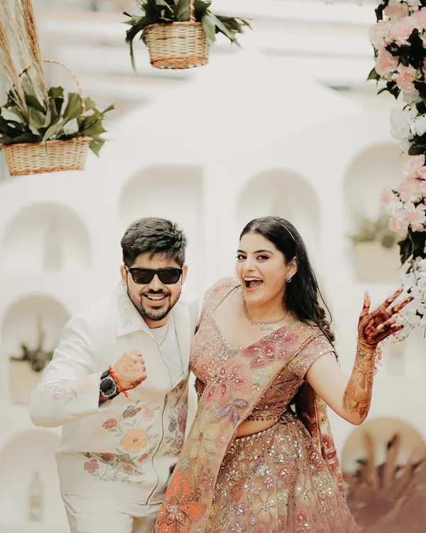 Pure fun and energy. This shot captures the couple's playful side during their pre-wedding festivities, their expressions full of excitement and joy.
