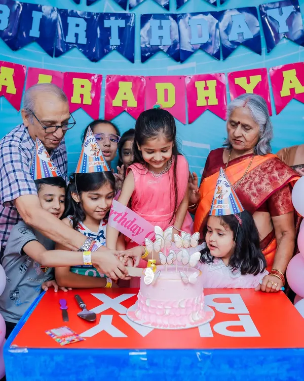 Grandparents joining in on the cake-cutting tradition. Our parties are designed for the whole family to enjoy and create lasting memories together.