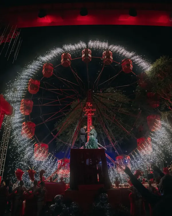 This is the kind of 'wow' moment I love to create. For this Sangeet night, we built a custom Ferris wheel, aptly named 'The Cosmic Love', which served as a spectacular backdrop for the couple's ring exchange, complete with a dazzling pyrotechnics show. It’s these unique, larger-than-life experiences that turn a wedding into a landmark event.