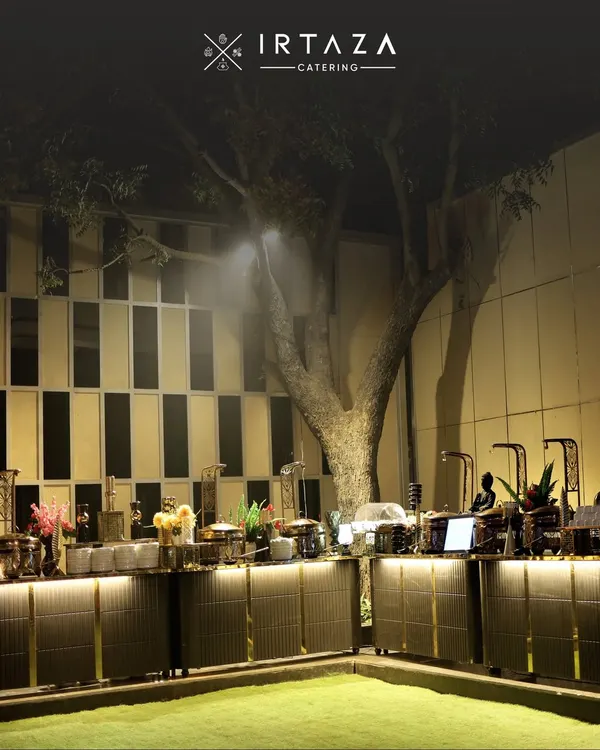 This is the essence of an Irtaza event. A grand, elegant buffet setup under the stars, where every detail from the illuminated counters to the premium serveware is meticulously planned to create a breathtaking first impression for your guests.